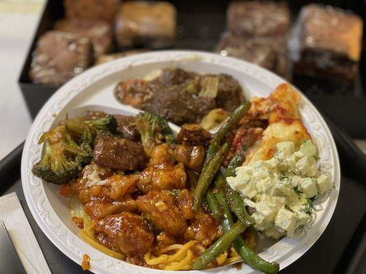 Orange chicken, green bean chicken, beef with broccoli, delicious lasagna, beef stew, and mashed potatoes. Tempting brownies in background.