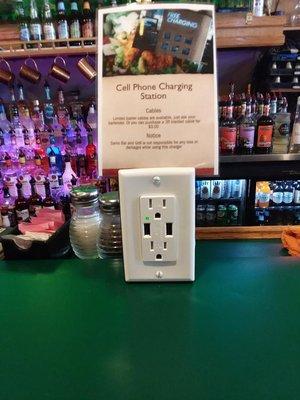 Laptop and cell phone charging stations available at the bar