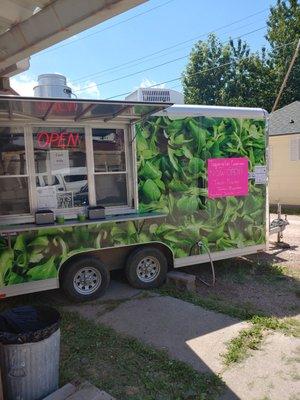 Our food truck, next to our indoor seating area.