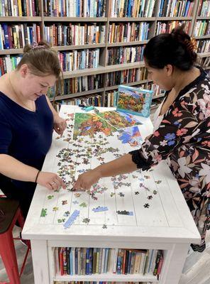 Try out the sample puzzle on one of the tables.  There's a great selection of new and used puzzles for sale.