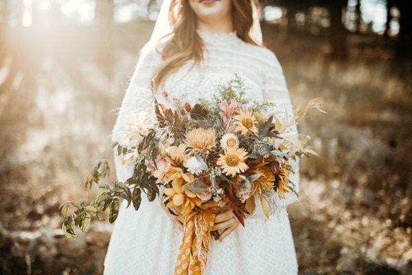 Wild boho bridal bouquet in the forest