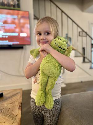 Daughter with forcibly exchanged grinch plushy.