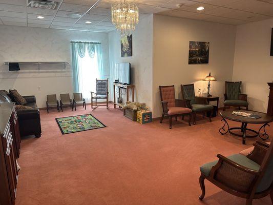 Family room with children's area that includes toys and a TV for cartoons.