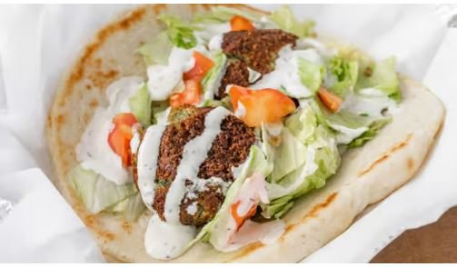 Falafel on Pita :
A Veggie Roll, Falafel, Salad in toasted pita topped with homemade Taziki sauce (White Sauce)