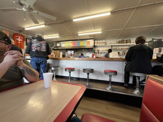 Bar seating with a few booths and tables