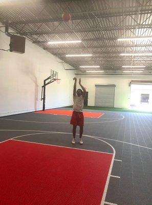 Basketball shooting drills in gym.