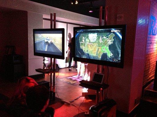 EGADS LCD screens on stands at a gaming event in NYC.