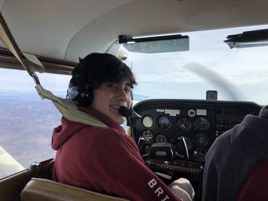 James in the pilot seat enjoying his first flight.