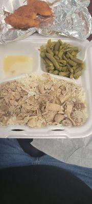 Chitlins over rice, green beans, and hushpuppies.