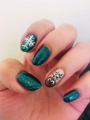 Gel manicure with snowflake and reindeer designs