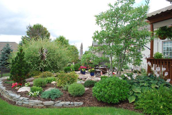 Landscape design with boulder features and patio by Landserv, Inc in State College PA, 16801