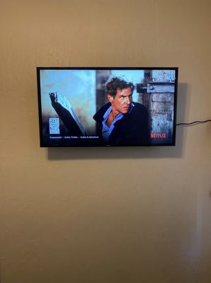 40" TV mounted on dry wall, with cord exposed