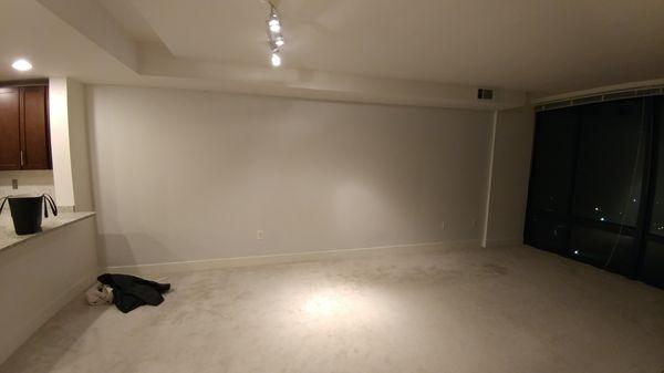 This primer white wall was deemed hard to paint and needed additional coats because it's a "custom color."