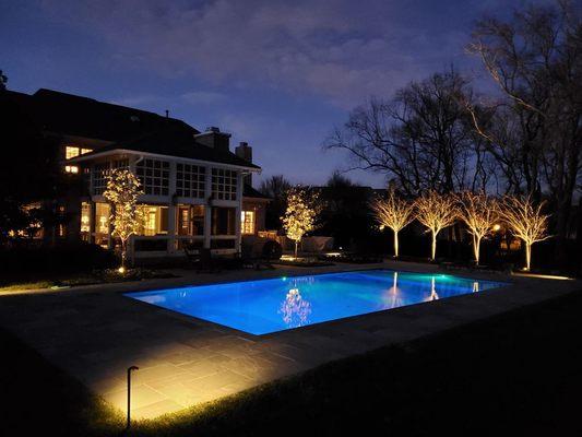 Dream Stone Escape Night Photo. Outdoor lighting around one of our custom pools in Brentwood TN Designed and built by Tennessee Custom Pools