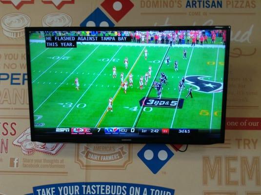 One of the TVs showing one of the NFL Wildcard games on ESPN.