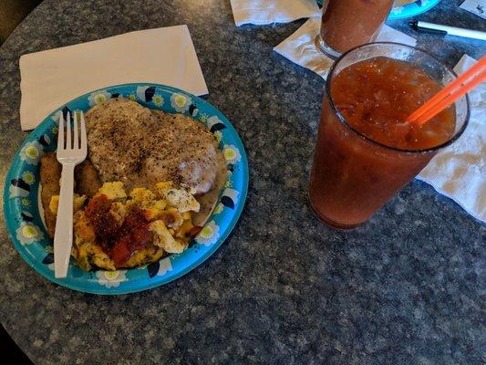 Some biscuits and gravy, sausage, scrambled eggs with some salsa, and a very spicy Bloody Mary. Yum!