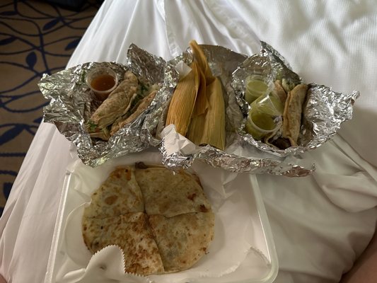 Two different types of tacos, two tamales and one quesadillas. More than enough for one bloke.