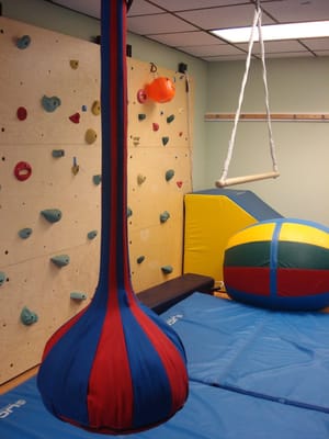 Climbing wall, swings, and squishy mats