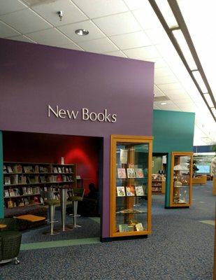 New book area. There are armchairs equipped with desks for laptops.