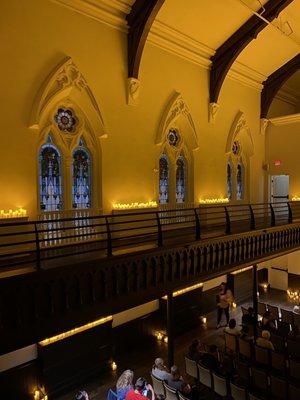 Left side view of balcony of the stain glass windows and beams