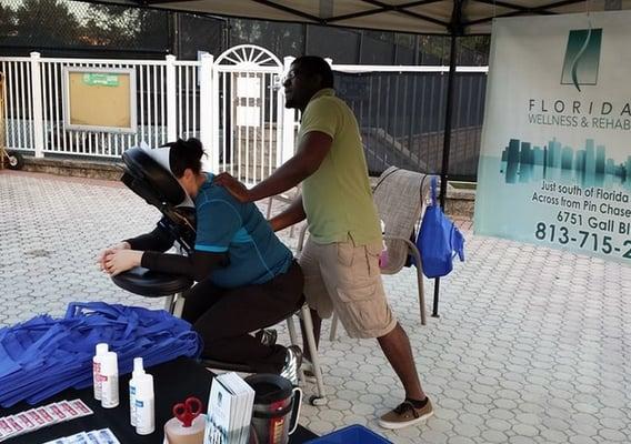 Kendall giving chair massages at an event