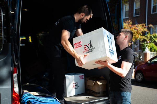 Elite Movers are loading the van with boxes