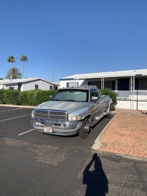 Old truck permanently parked in public parking lot.