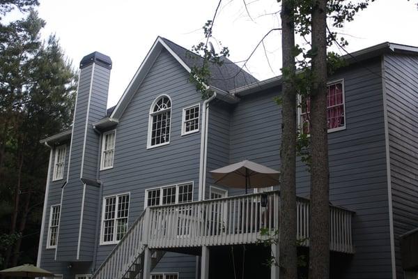 New, fiber cement siding, exterior paint and roof by Legendary Renovations.