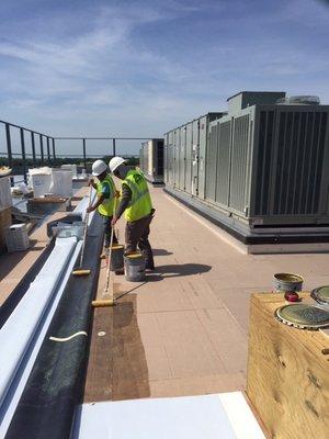 Fully adhering the new roof membrane to the newly installed roof insulation.