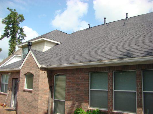 1st Home:
 The rear of the home with new roof.