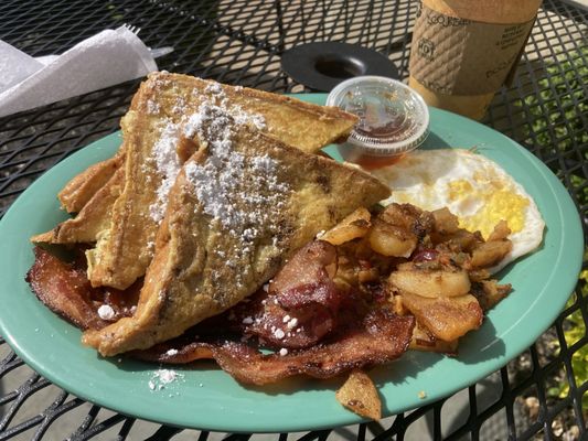 French toast with bacon, potatoes, and egg.