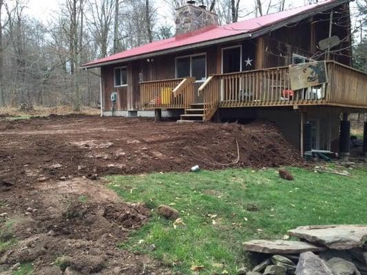 Leveling the front yard after new drainage system was installed.  This is only the top soil, grass seed to follow.