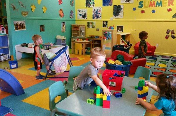 Toddlers enjoying free choice time in their classroom.