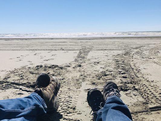 Feet in the sand sand and enjoying the beach and sounds of the waves