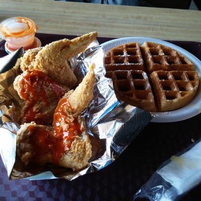 Three wings and a waffle combo. Hot sauce on the side.