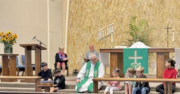 Pastor Michael giving his lesson for lambs during church service