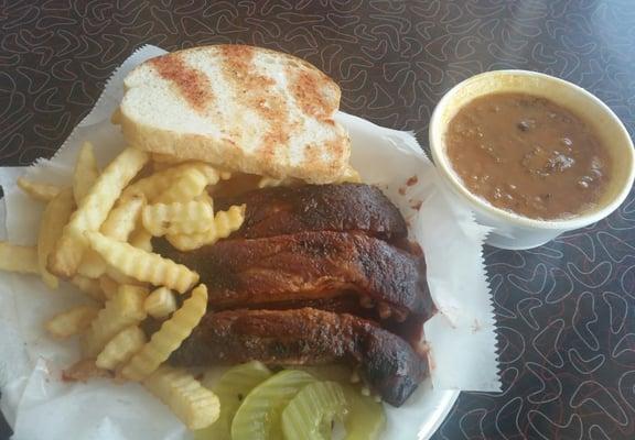 Rib sandwich, beans and fries.