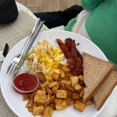 Eggs, toast, and bacon entree pictured here after seasoning the eggs.