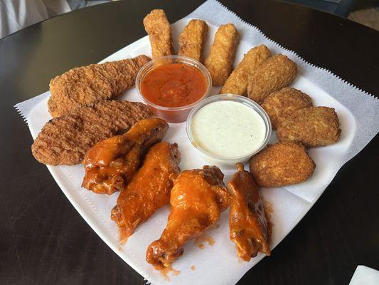 Appetizer sampler. Chicken tenders, mozzarella sticks, fried jalapeños, buffalo chicken wings