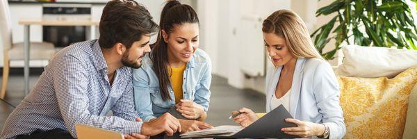 Mortgage Broker explaining there loan terms to a happy couple.