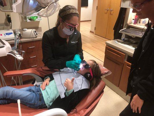 Thumbs up during dental visit laid back and watching TV