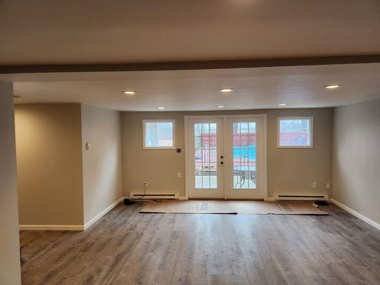 Basement flood damage. Wall finishing and painting. LifeProof flooring. Baseboard trim.