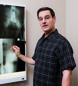 Dr. Howell reviewing X-rays. Denton chiropractic clinic and physical wellness.