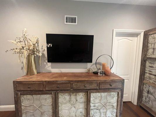 Mounted 42" TV in bedroom. Wires and cable all behind the TV.