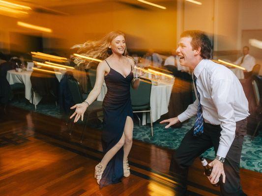 Shutter drag effect on wedding guests dancing and partying on wedding reception dance floorw