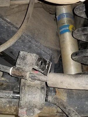 Emergency brake cable bracket left unattached