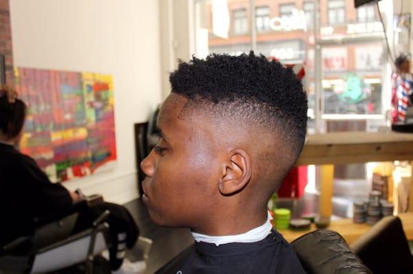 bald fade finished off with curl sponge on top.