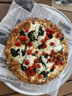 White pizza with ricotta, spinach, and cherry peppers