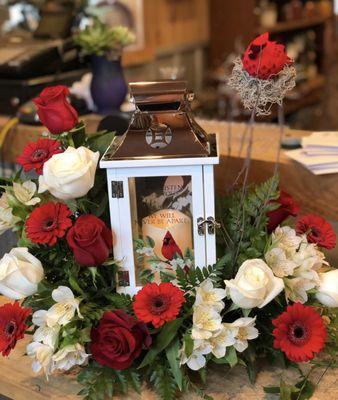 Funereal lantern of red roses, gerbs, white roses and alstroemerias.