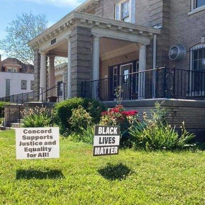 Signs on the lawn outside Pathway Clubhouse saying "Concord Supports Justice and Equality for All!" and "Black Lives Matter!"